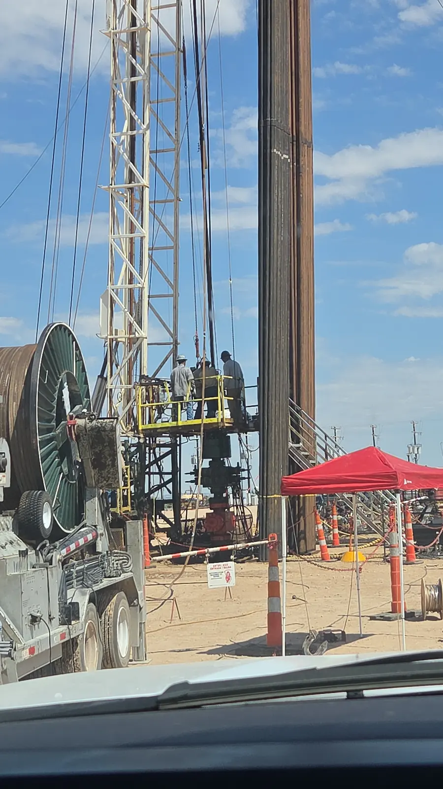 A coiled tubing unit with crew on the rig floor