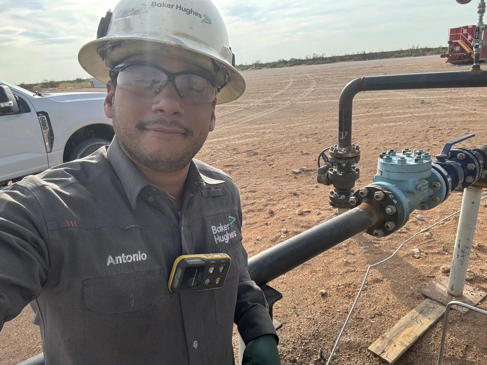 Antonio Marzal in a Baker Hughes hard hat and uniform at a wellsite